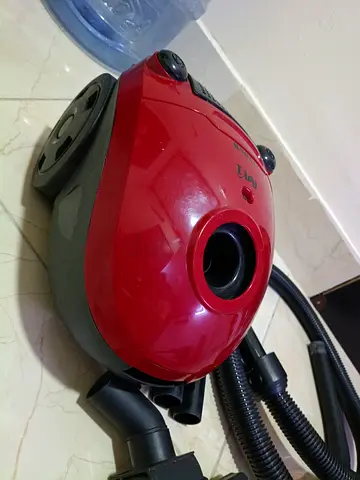 Compact red canister vacuum cleaner - working condition