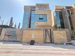 Villa for sale in Ajman, Al Helio 2 area. It consists of a ground floor, first floor, and roof, feat