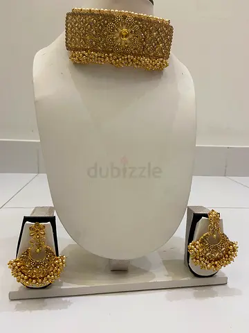 Gold-tone traditional bridal necklace set with matching earrings and maang tikka