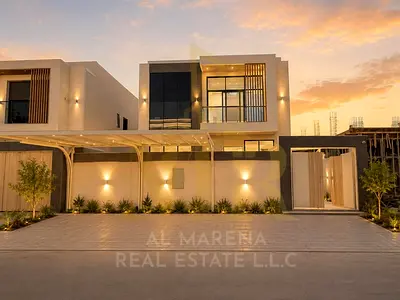 Own a villa for sale in the heart of Al Helio 2, Ajman, with a price that includes registration and ownership fees, electricity, water, and air condit