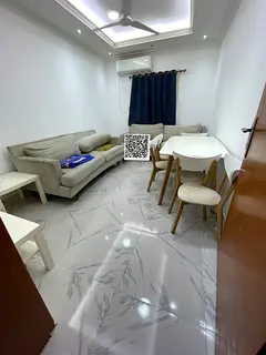 Fully furnished two-bedroom apartment with luxury finishing, two bathrooms, a balcony, and ready-to-
