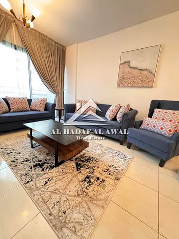 For Monthly Rent Two-bedroom apartment with a living room in the Al Khan area, featuring stylish furnishings.