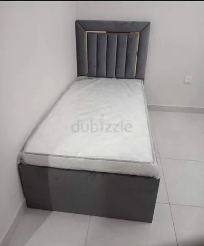 Single grey upholstered bed with mattress - good condition
