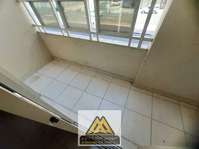 Two-bedroom apartment with separate living room and balcony in Al Nuaimiya 2, prime location near Gulf Bridge and easy access to Sharjah and Dubai