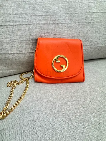 Gucci Orange leather wallet with gold chain and logo