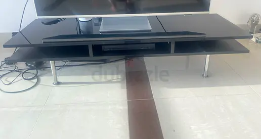 Black metal TV stand with chrome legs - good condition