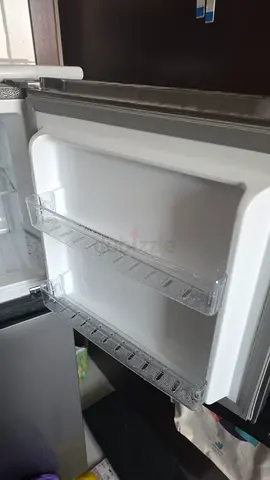refrigerator in good working condition, door shelves intact