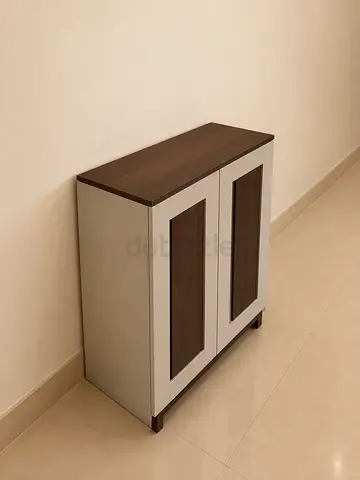 Compact two-door storage cabinet with wood finish top
