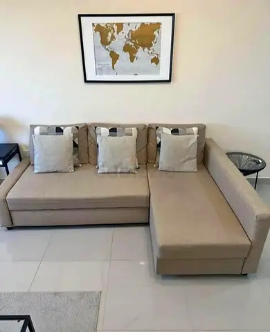 Light beige L-shaped sectional sofa with storage chaise