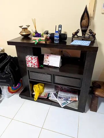 Dark wooden console/entry table with drawers and open shelves