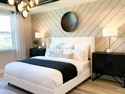 White upholstered double bed frame with headboard