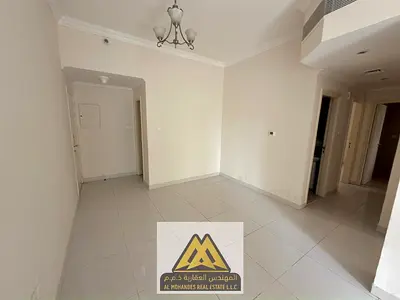 2BR hall Al Nuaimiya 1 Ajman, balcony, 2 baths, central AC, prime location, 34k yearly, 4 payments.