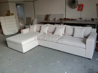 L-shaped beige fabric sofa with chaise