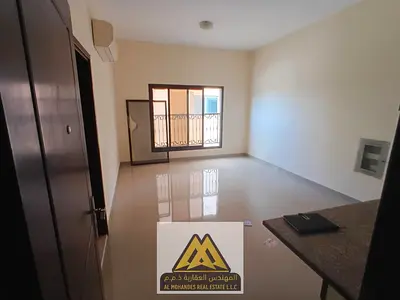 A spacious studio apartment for annual rent in Al Rawda 2 Ajman, located directly on Sheikh Ammar Road, offering a comfortable layout, bright interior