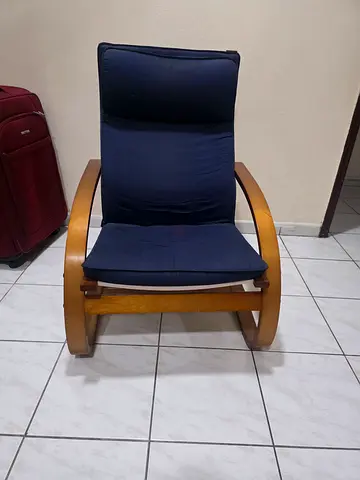 Wooden frame rocking lounge chair with navy cushions