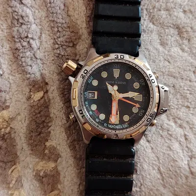 Used mens diver-style wristwatch with black rubber strap