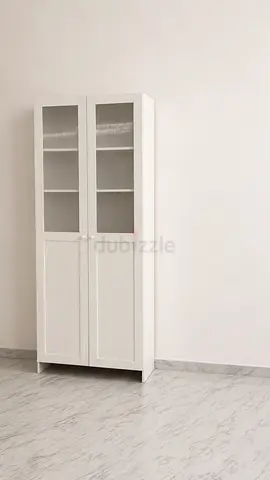 White bookshelf with glass door