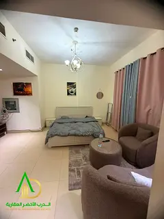 Spacious furnished studio for monthly rent in Al Yasmeen Towers, Tower B6, Ajman. Features a separat