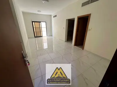 A spacious one-bedroom apartment with a balcony in Al Nuaimiya 1 area, close to Al Hikma School and all services.