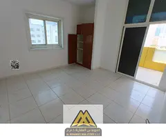 Annual rent: 2-bedroom apartment in Al Rashidiya 3 with balcony, 2 bathrooms, built-in wardrobes, ce