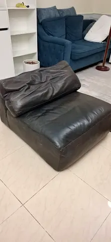Black leather lounge chair ottoman — single modular seat (used)
