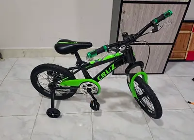 Cruz kids 16-inch green black bike with training wheels - good condition