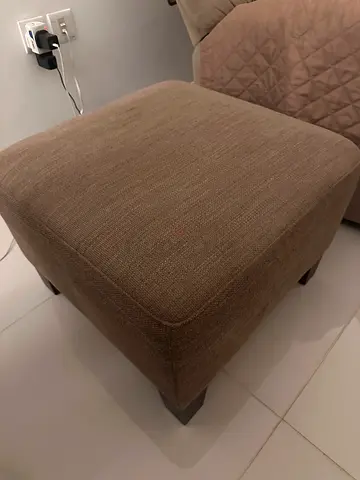 Brown fabric ottoman/footstool in good condition