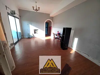 Large studio in Al Nuaimiya 1 with central AC, balcony, semi-separated kitchen, second tenant, 17,000 AED yearly, 4 payments, near Al Ittihad Street.