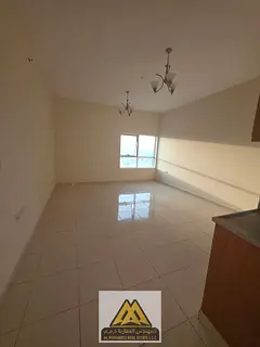 A spacious studio apartment is available for annual rent in Orient Towers, Al Bustan, Ajman. The apa
