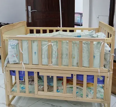 Solid Wooden Baby Crib with Bumper and Under-crib Storage - Good Condition.
