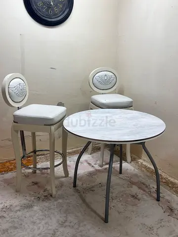 Small round marble-top dining table with two cushioned chairs - compact set