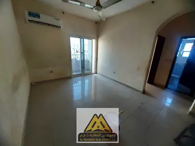 One-bedroom apartment with a living room in Al Nuaimiya 2, spacious layout, balcony, kitchen, and bathroom, 25,000 AED yearly, 4 payments, near the pa