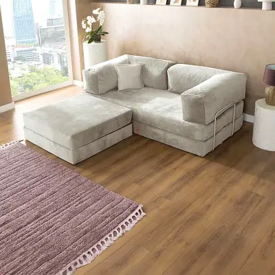 Light grey L-shaped modular sofa with ottoman