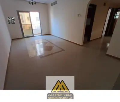 For rent: 2-bedroom apartment with hall in Al Nuaimiya 1, Ajman. Balcony, 2 bathrooms, central AC, prime location close to services, Dubai and Sharjah