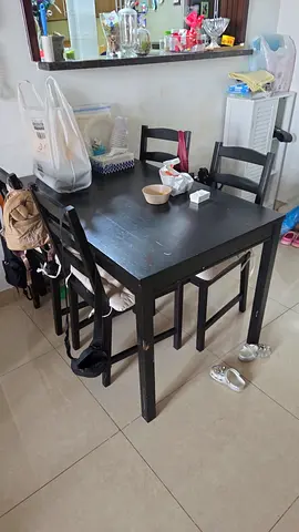 Solid black wooden dining table with 4 chairs - good condition