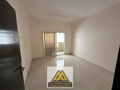A spacious one-bedroom apartment with a balcony in Al Nuaimiya 1 area, close to Al Hikma School and all services.