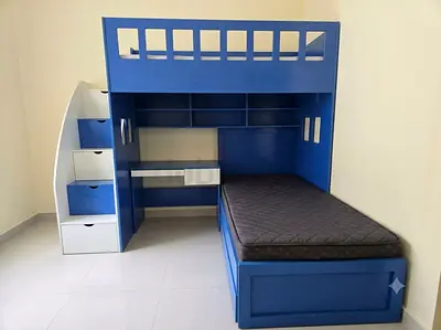 Blue wooden bunk bed with built-in desk and storage - good condition