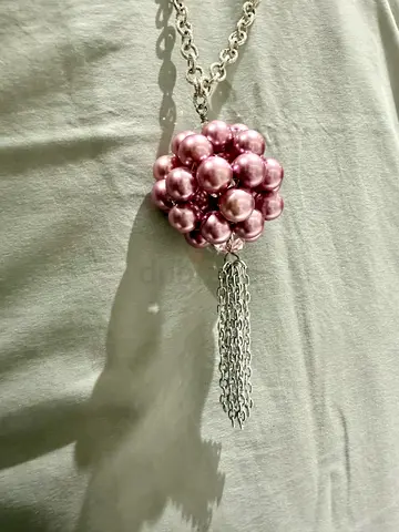 Long chain necklace with pink faux pearl cluster pendant and tassel