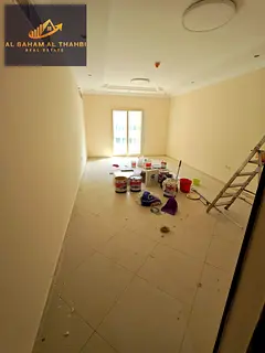 Two-bedroom apartment with a living room, balcony, and free parking for rent in Al Taawun.