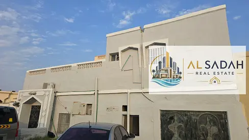 For sale: Corner house in Umm Khanoor. It has three sections: Section 1 has 3 bedrooms, a living room, and a kitchen (currently rented for 25,000). Section 2 has 2 bedrooms, a living room, and a kitch