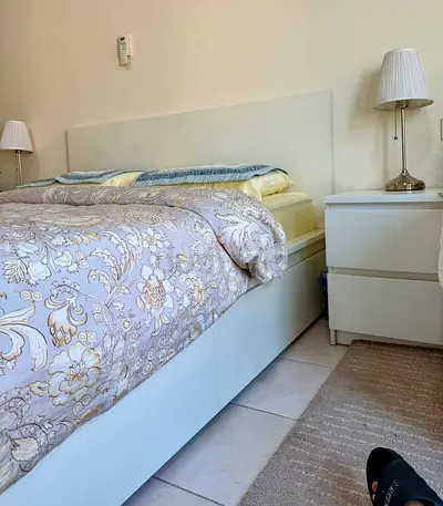 White double bed frame with storage and matching bedside table - good condition