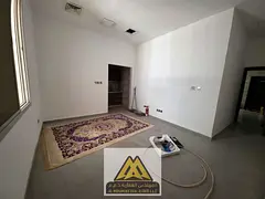 Annual studio for rent in Al Rawda 1, spacious ground floor, new building, semi-separated kitchen, c