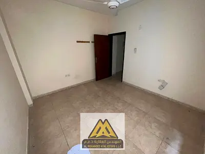 A one-bedroom apartment with a living room for annual rent in Al Rashidiya 1, Ajman, in a prime location on Al Mina Street, opposite the fish market,