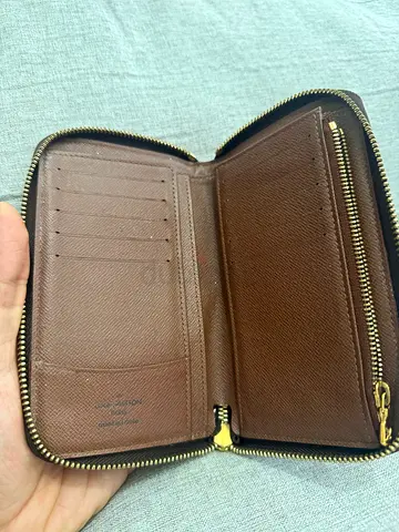Louis Vuitton Brown zip-around leather wallet with card slots and coin pocket