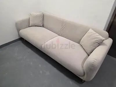 Modern Grey Three-Seater Sofa with Matching Pillows