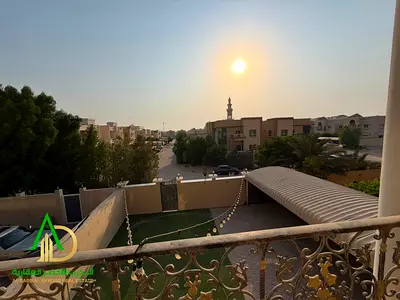 Villa for rent in Muwaihat 1: features five master bedrooms, a majlis, a living area, a balcony, a prep kitchen, and a spacious yard. Located next to