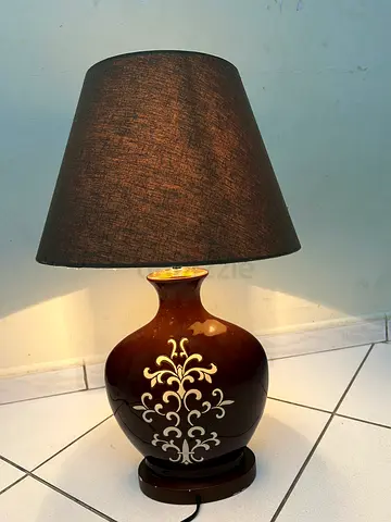Brown ceramic table lamp with patterned base and dark fabric shade