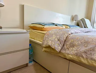 White double bed frame with storage and matching bedside table - good condition