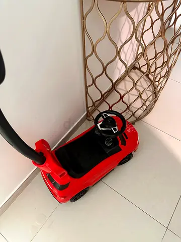 Red push ride-on car with parental handle - good condition