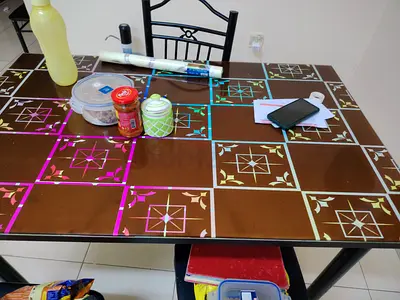 4-seater glass top dining table with metal frame